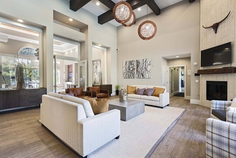 A living room with a white couch and a fireplace.