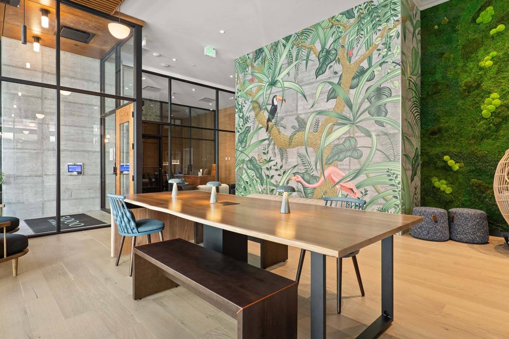A lounge area with a long table and chairs at Windsor 3000 Huron, 3000. N. Huron Street, Denver, CO 80202. A lounge dining area at Windsor 3000 Huron, 3000. N. Huron Street, Denver, CO 80202.