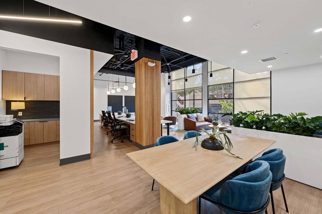 A conference room with a long table and chairs.