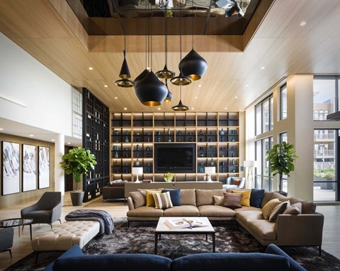 A modern living room with a large sectional sofa and a coffee table.