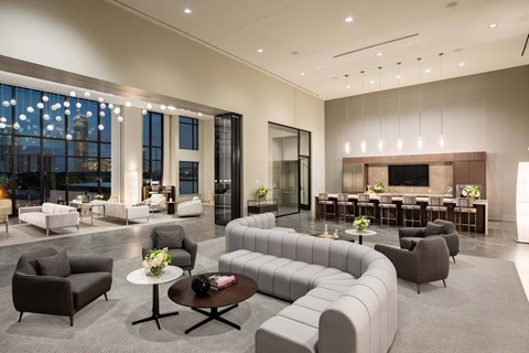 A modern living room with a large grey sofa and a coffee table.
