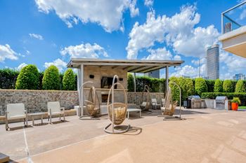 a patio with chairs and a fireplace