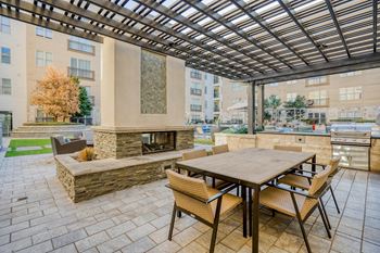 Pool courtyard with cabanas, covered seating, and dual-sided fireplace