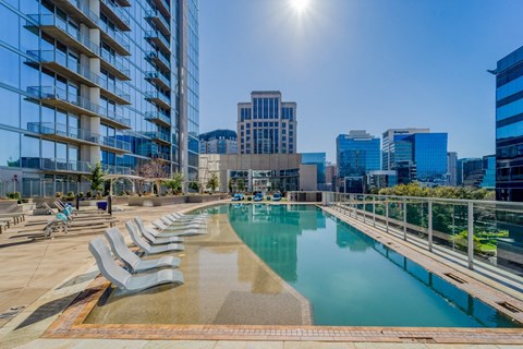 Pool deck with lounge chairs at Glass House Dallas, Texas