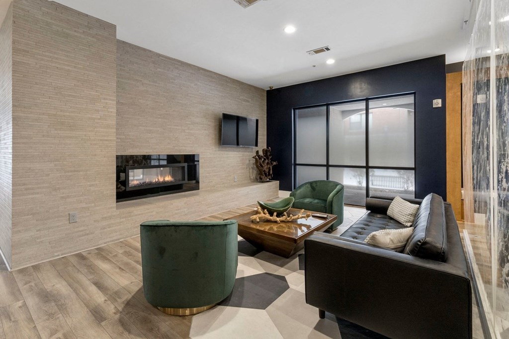 Resident clubhouse lounge featuring fireplace and tv at The Manhattan Tower and Lofts, Denver, 80202.