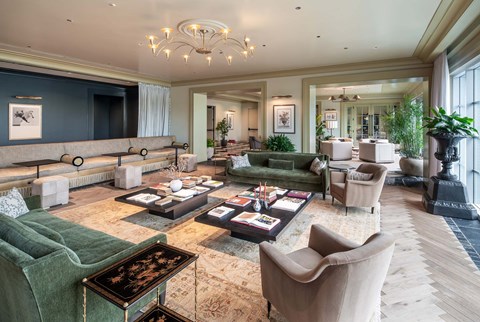 A living room with a green sofa and a coffee table.