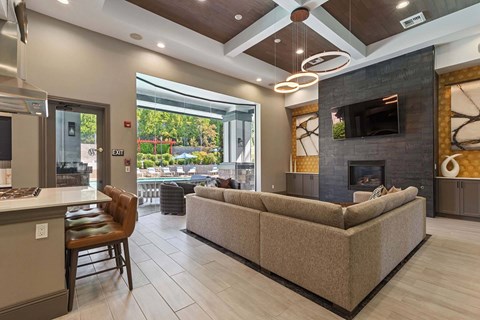 A modern living room with a fireplace and a large couch.