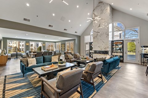 a large living room with couches and chairs and a fireplace