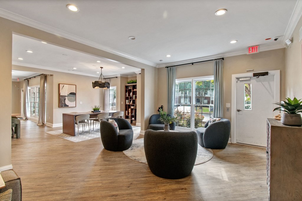 A spacious living room with a wooden floor and a large window.