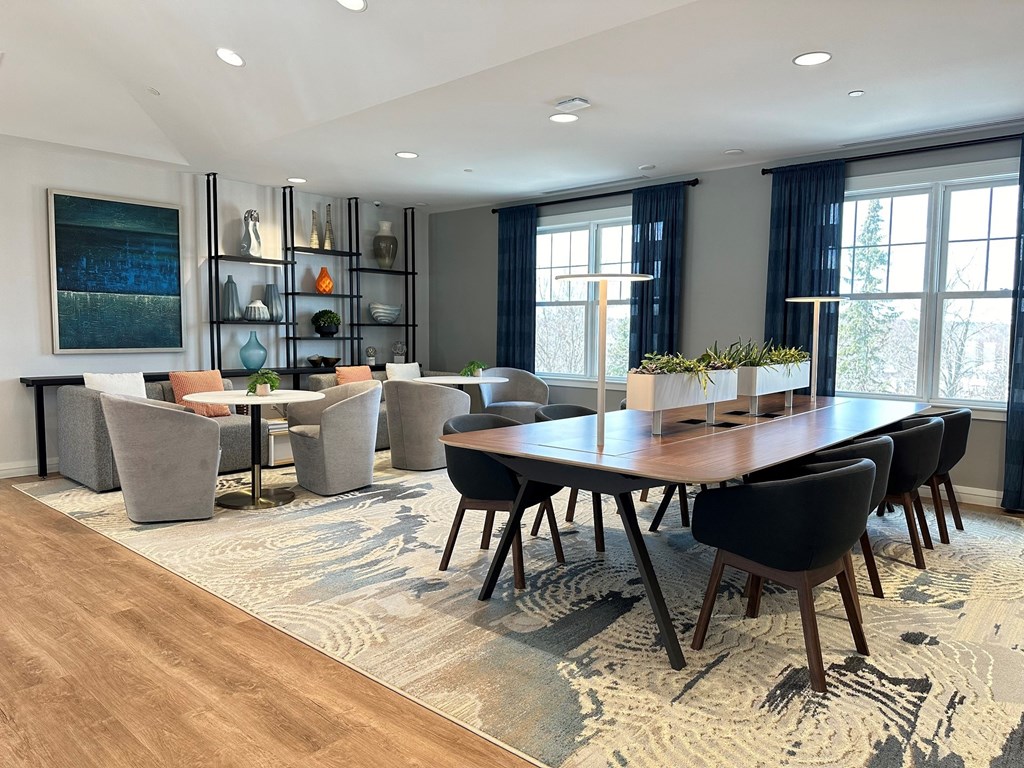 a dining room and living room with a large table and chairs