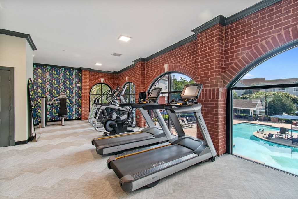 A home gym with treadmills and elliptical machines.