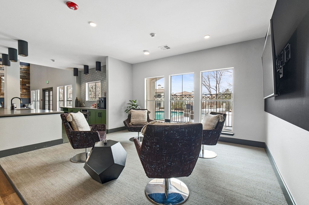 Living room with chairs and a kitchen and a balcony at Windsor Westminster, Westminster, Colorado