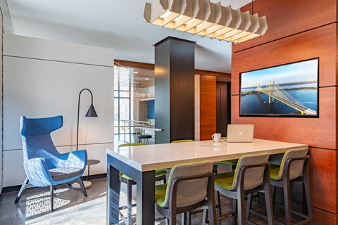 a kitchen with a table and chairs and a laptop computer on a desk