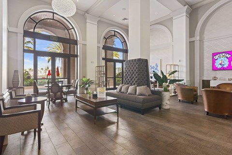 A modern living room with a large sofa and a TV screen.