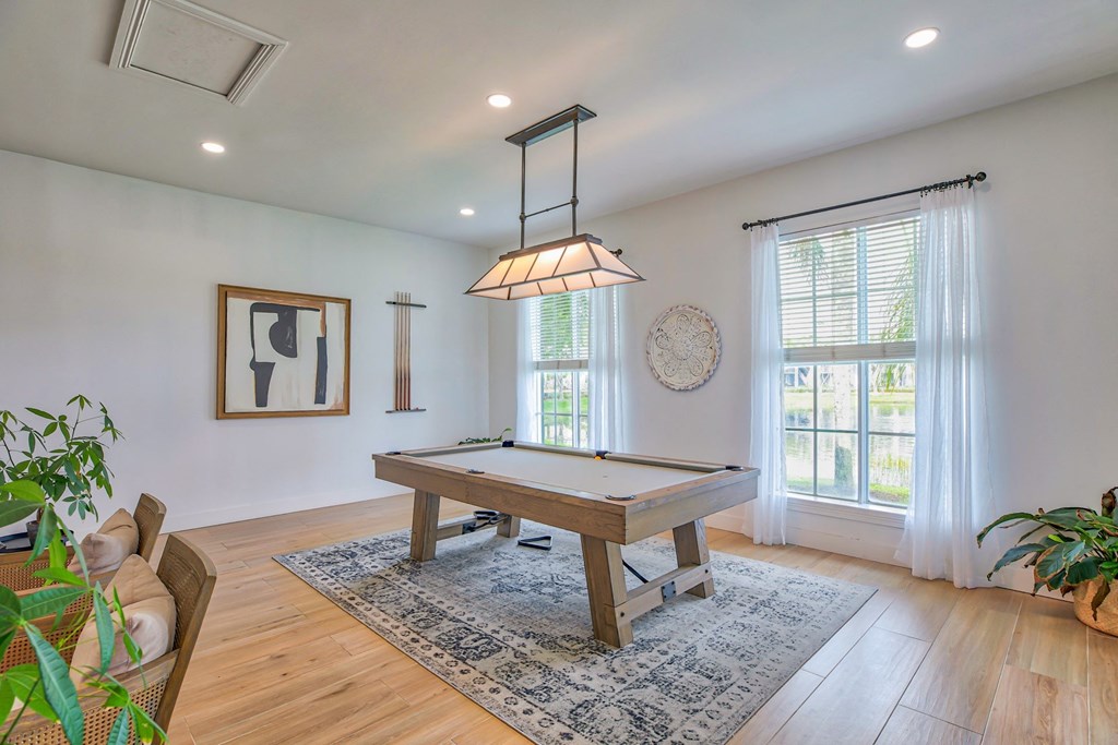 Common area space in clubhouse with a pool table and modern decor