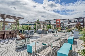 an outdoor patio with tables and benches and umbrellas