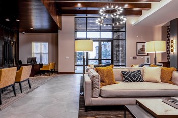 Leasing Office and Clubhouse with White Armchairs on Area Rug with Coffee Tables Leasing Office and Clubhouse with White Armchairs on Area Rug with Coffee Tables at Windsor Castle Hills, Carrollton, 75010 - Photo Gallery 3
