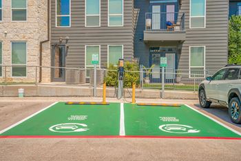 a parking lot with a bike rack in front of an apartment building