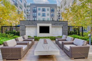 a seating area with couches and a coffee table in front of a fireplace