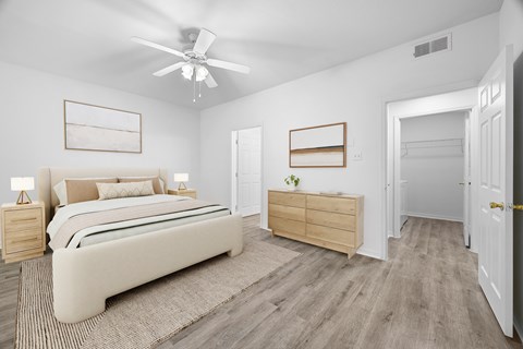 A bedroom with a bed, dresser, and mirror.