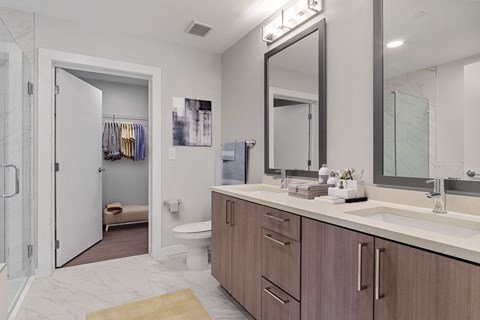 a bathroom with a large mirror and a toilet and a shower