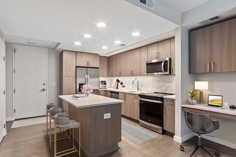a kitchen with an island and a bar with stools