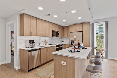 a kitchen with wooden cabinets and a white counter top