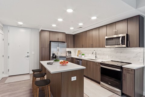 a kitchen with wooden cabinets and a white counter top