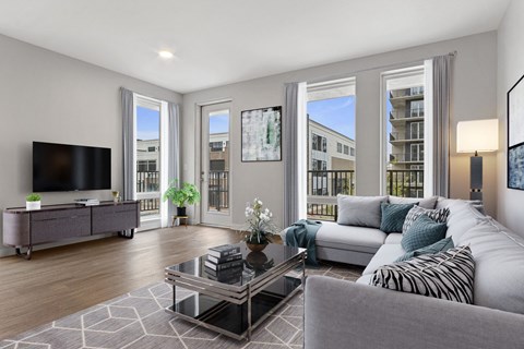 an apartment living room with a couch and a tv