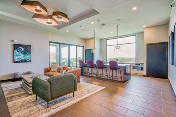 a living room with a couch chairs and a coffee table