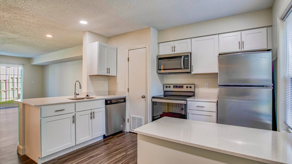 Elegantly renovated kitchens with modern finishes a kitchen with white cabinets and stainless steel appliances and abundant storage space at Windsor Ridge at Westborough, 1 Windsor Ridge Drive, Westborough