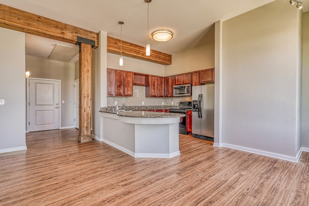 A kitchen and living room with a wooden floor at The District, Denver, CO