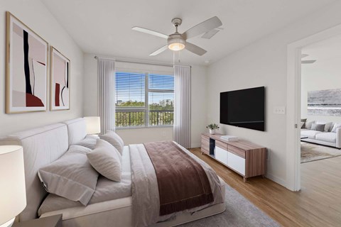 A bedroom with a large bed and a flat screen TV mounted on the wall.