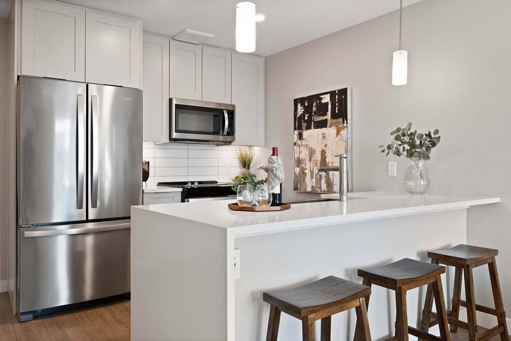 A modern kitchen with stainless steel appliances and white cabinets at Windsor 3000 Huron, 3000. N. Huron Street, Denver, CO 80202. A modern kitchen with stainless steel appliances and white cabinets at Windsor 3000 Huron, 3000. N. Huron Street, Denver, CO 80202.