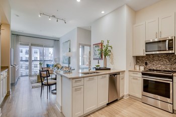 Stunning kitchens feature quartz countertops and tiled backsplash. Stunning kitchens feature quartz countertops and tiled backsplash at Windsor Mystic River, Massachusetts, 02155 - Photo Gallery 2