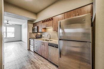 a kitchen with wooden cabinets and stainless steel appliances