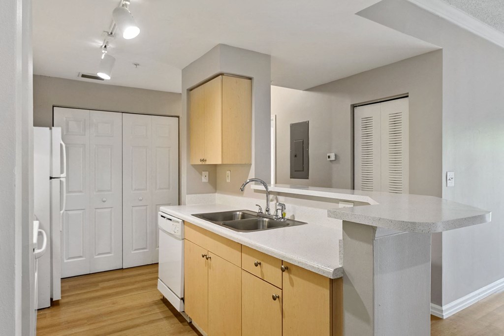 A kitchen with white countertops and wooden cabinets at The Winston by Windsor, Pembroke Pines, Florida