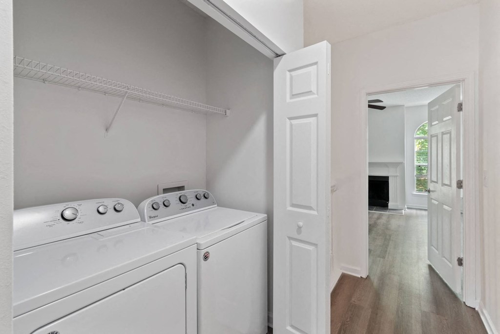 A white laundry room with a dryer and washer.