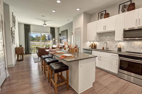 a kitchen and dining room with a table and chairs