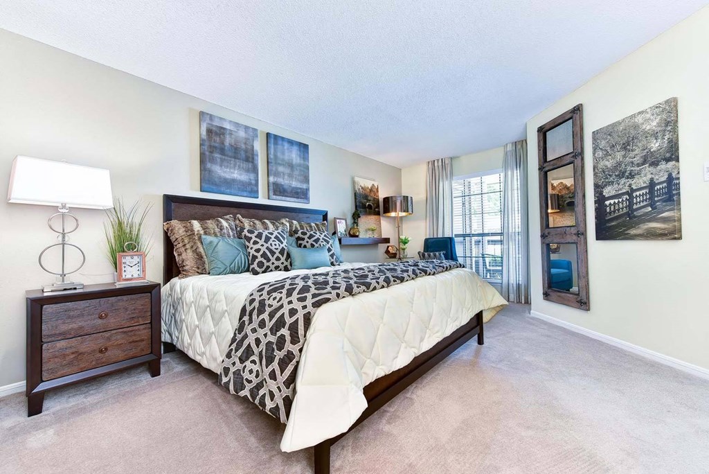 Windsor Oak Creek' bedroom with a bed and a doorway to a balcony in Fairfax VA