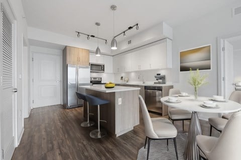 an open kitchen and dining area with a table and chairs