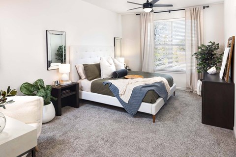a bedroom with a bed and a ceiling fan