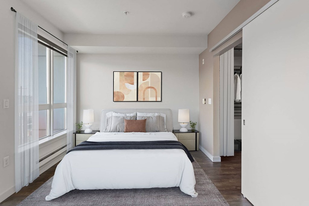 A bedroom with a large bed and a painting above it.