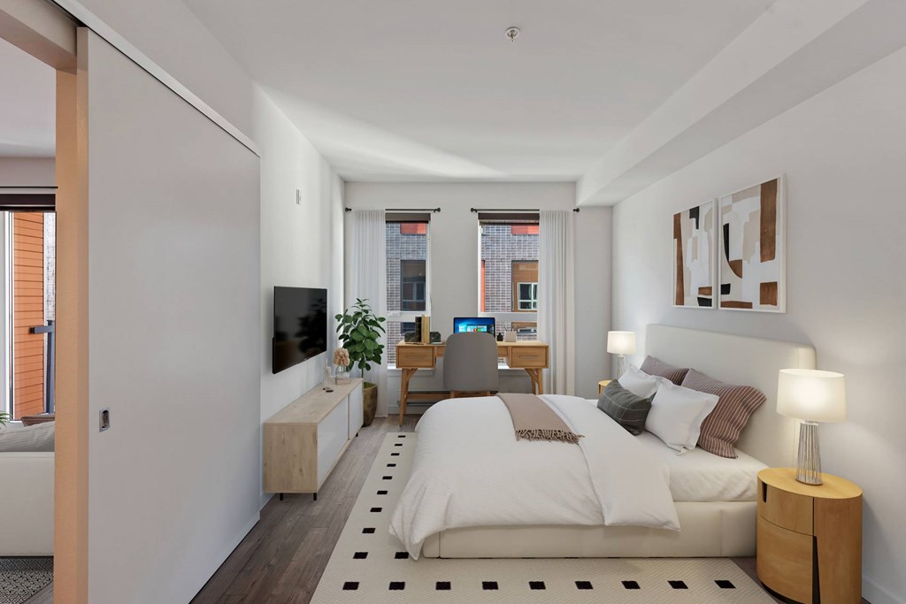 A modern bedroom with a large bed and a flat screen TV.