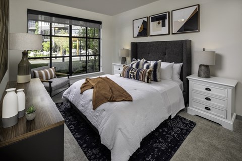a bedroom with a large bed and a large window