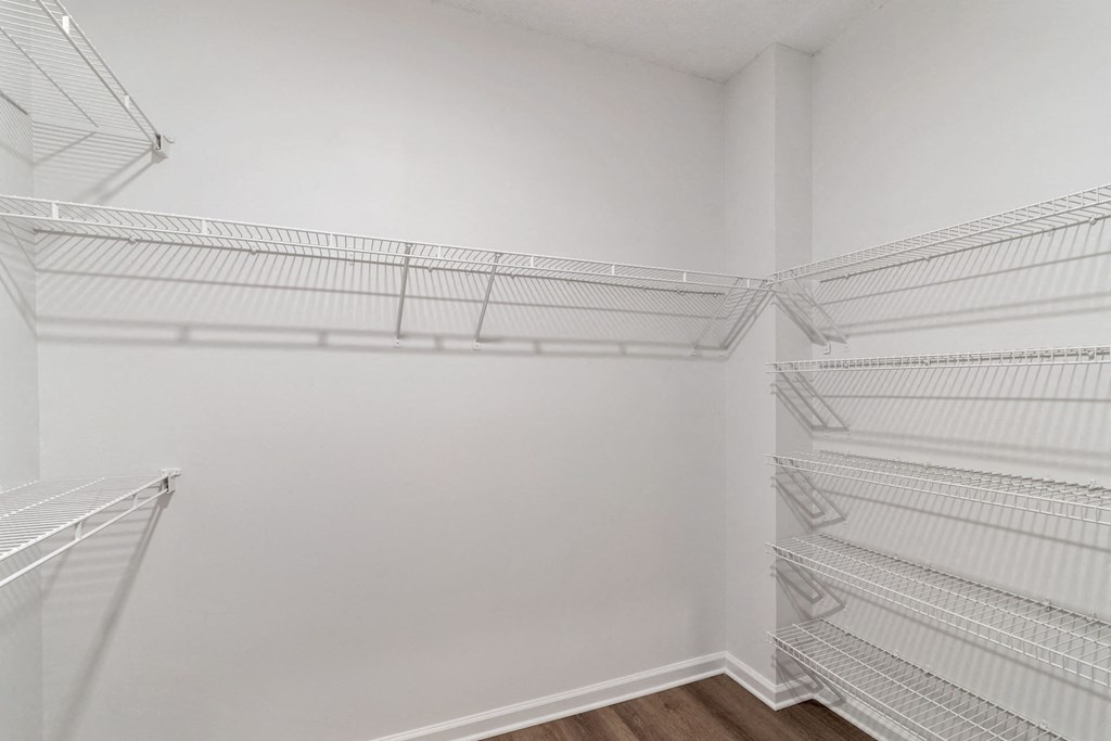 Empty white shelves in a room.
