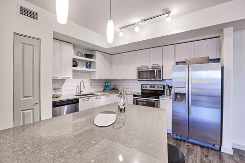 a kitchen with stainless steel appliances and granite counter tops