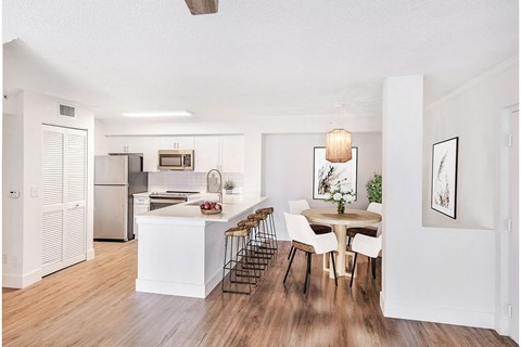 an open kitchen and dining room with a table and chairs