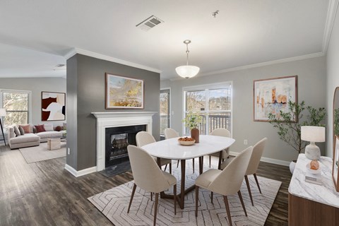 Dining area with table seating, fireplace, and open view into the living space at Windsor Kennesaw, 1925 Old 41 Highway Northwest, Kennesaw, GA 30152