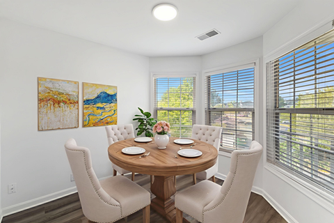 Spacious dining area with large windows at Windsor Kingstowne, 6050 Edgeware Ln, Alexandria, VA.